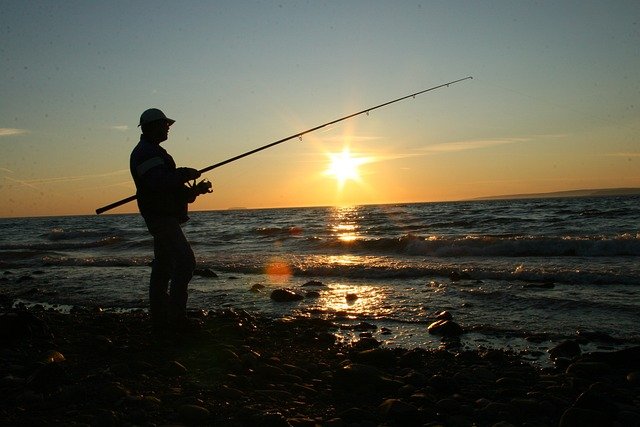 Fishing at the shore in Galveston, watching the sunset at dusk, is the perfect way to end a long day.
